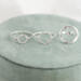 Three open circle sterling silver rings (small, medium, large with hammered finish) on green ring box with flowers.

